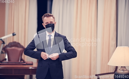 Image of business man wearing protective face mask at office