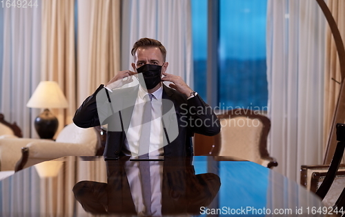 Image of business man wearing protective face mask at office