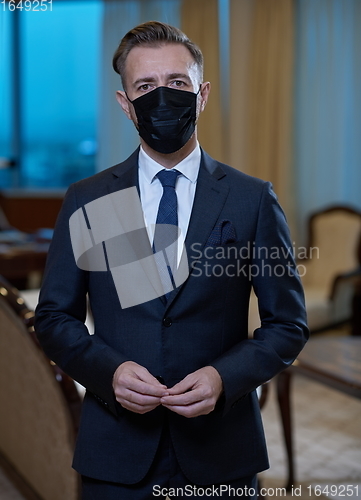 Image of business man wearing protective face mask at office