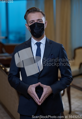 Image of business man wearing protective face mask at office