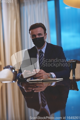 Image of business man wearing protective face mask at office