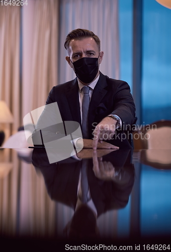 Image of business man wearing protective face mask at luxury office