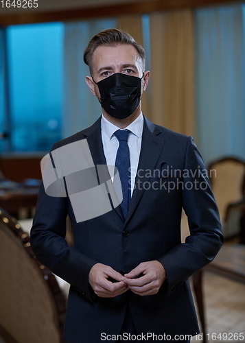 Image of business man wearing protective face mask at office