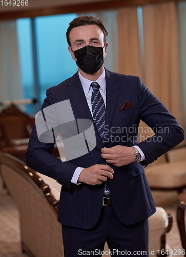 Image of business man wearing protective face mask at office