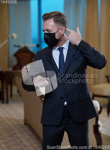 Image of business man wearing protective face mask at office