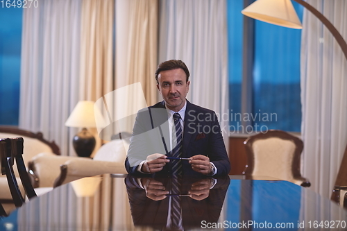 Image of corporate businessman at luxury office pen holding 