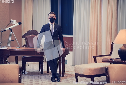 Image of business man wearing protective face mask at office