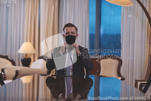 Image of business man wearing protective face mask at office