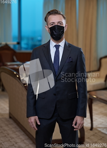 Image of business man wearing protective face mask at office