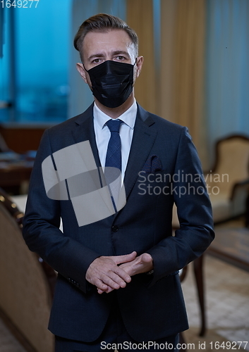 Image of business man wearing protective face mask at office