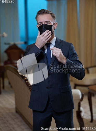 Image of business man wearing protective face mask at office