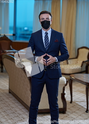 Image of business man wearing protective face mask at office