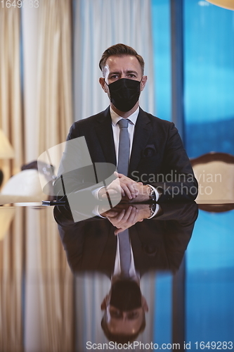 Image of business man wearing protective face mask at luxury office