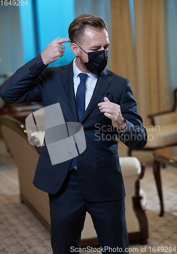 Image of business man wearing protective face mask at office