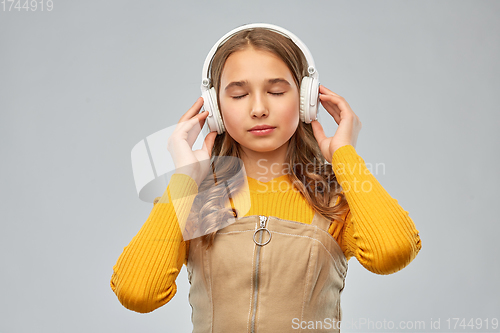 Image of teen girl in headphones listening relaxing music