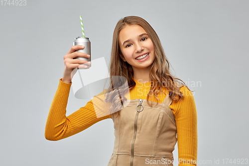 Image of happy teenage girl drinking soda from can