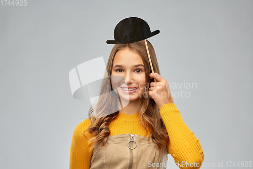 Image of smiling teenage girl with black vintage bowler hat