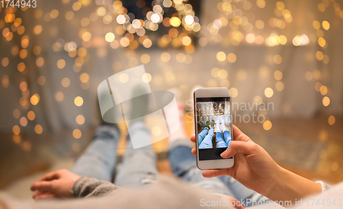 Image of close up of couple taking foot photo by smartphone