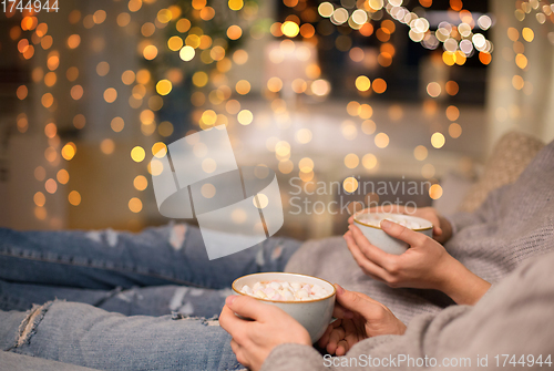 Image of close up of couple drinking hot chocolate at home