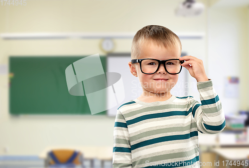 Image of portrait of smiling boy in glasses at school