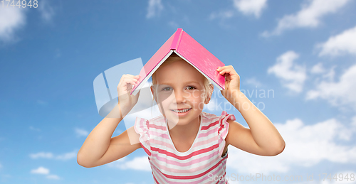 Image of little girl with roof of book on top of her head