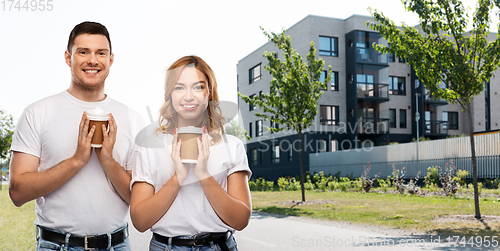 Image of portrait of happy couple with takeaway coffee cups