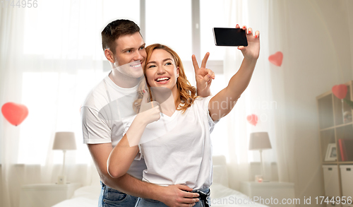 Image of happy couple taking selfie on valentines day