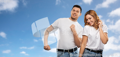 Image of portrait of happy couple in white t-shirts dancing