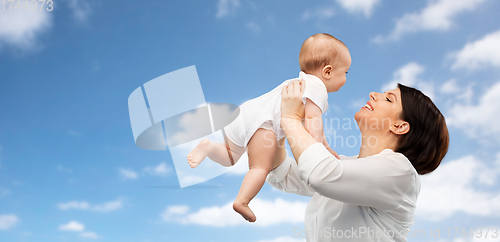 Image of happy middle-aged mother with little baby daughter