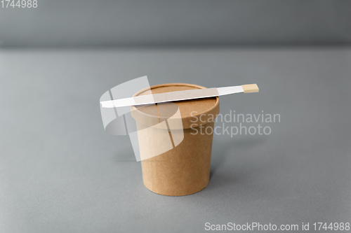 Image of paper container for takeaway food with chopsticks