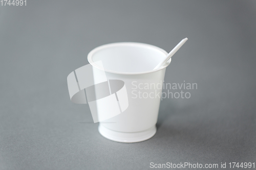 Image of white disposable plastic cup with spoon