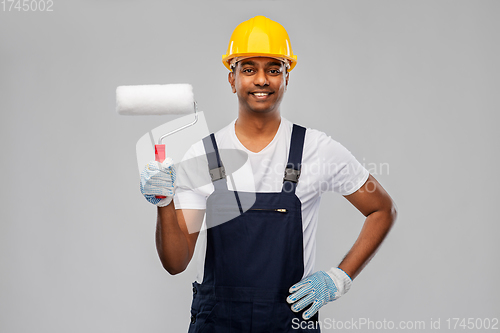 Image of happy indian painter or builder with paint roller