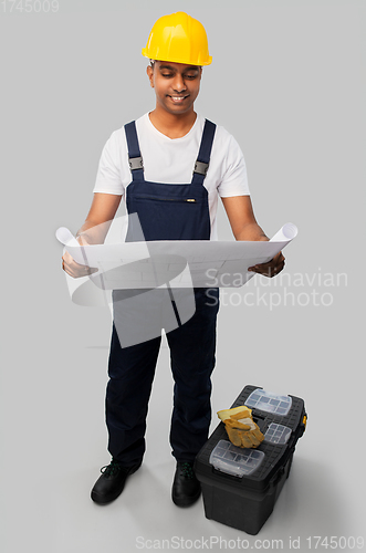 Image of happy indian builder with blueprint and tool box