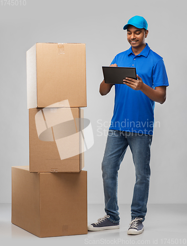 Image of indian delivery man with tablet pc and boxes