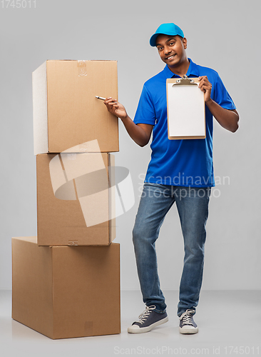 Image of indian delivery man with boxes and clipboard