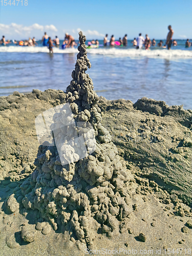 Image of Sand castle and crowded beach background