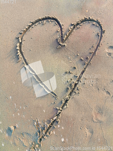 Image of Drawing heart symbol on sand