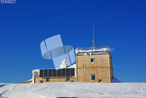 Image of Wooden chalet on mountain summit