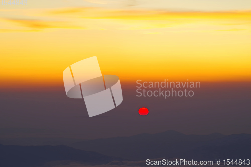 Image of Sunrise at the horizon over mountains