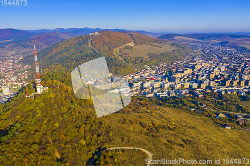 Image of Aerial view of antenna tower and city in the valley