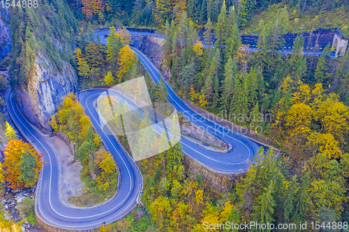 Image of Uphill winding road in autumn mountain