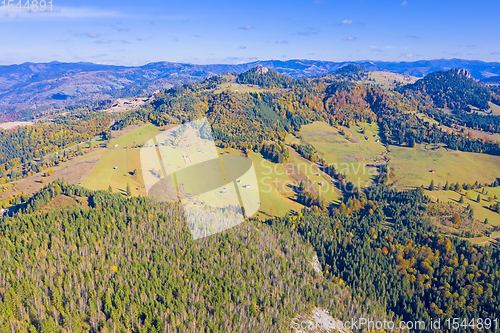 Image of Aerial meadows and forest in autumn mountain