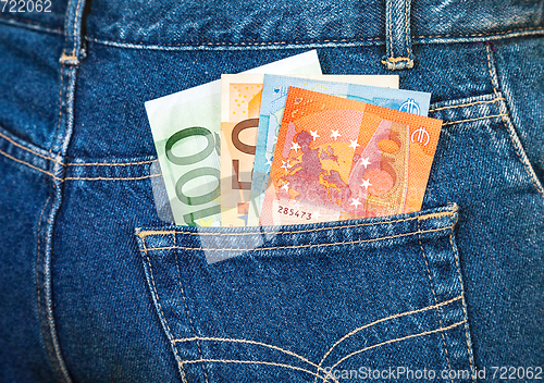 Image of Euro banknotes sticking out of the blue jeans pocket. Money for 