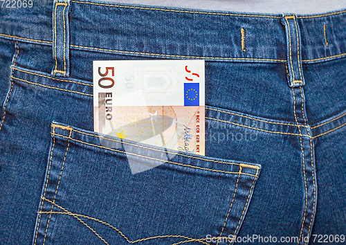 Image of Banknote 50 euro sticking out of the blue jeans pocket. Money fo