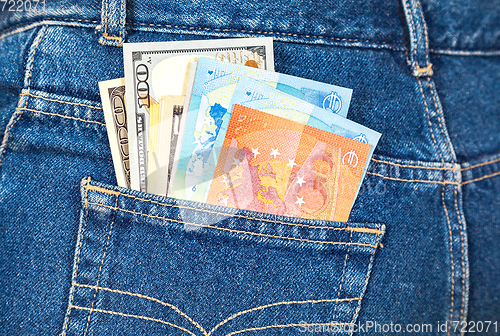 Image of Euro and american currency, money in jeans pocket for travel and