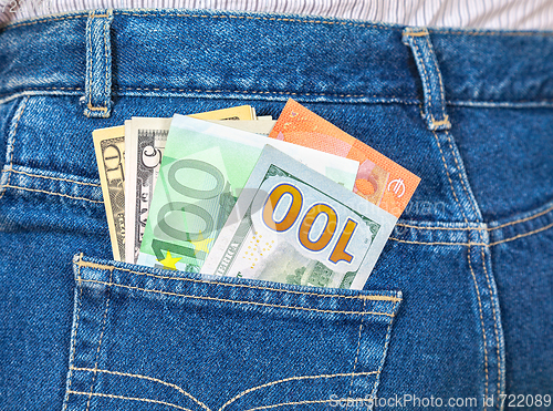 Image of Euro and american currency, money in jeans pocket for travel and