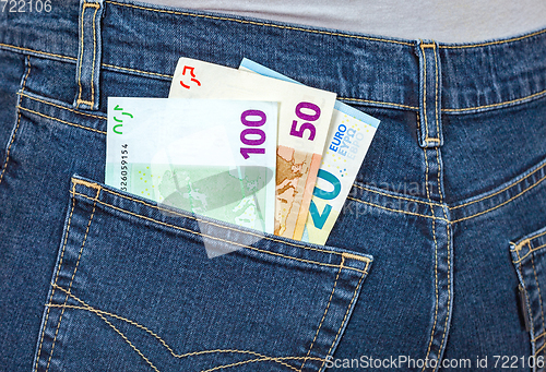 Image of Euro banknotes sticking out of the blue jeans pocket. Money for 