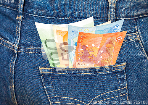 Image of Euro banknotes sticking out of the blue jeans pocket. Money for 