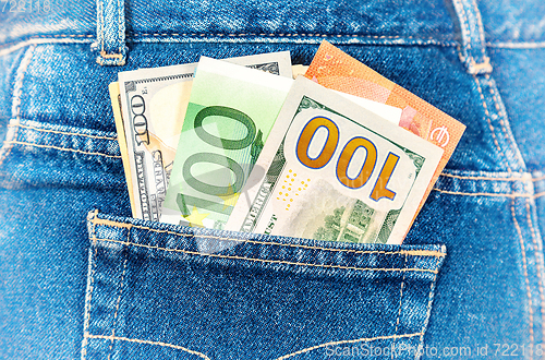 Image of Euro and american currency, money in jeans pocket for travel and