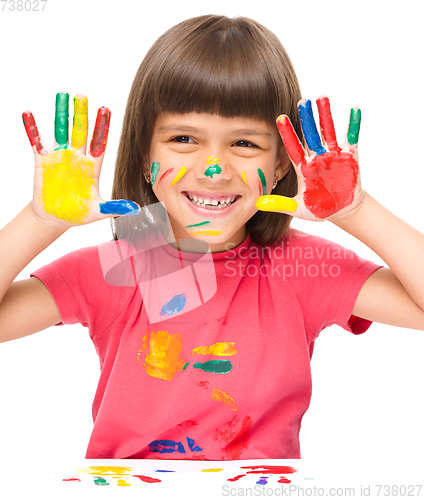 Image of Portrait of a cute girl playing with paints